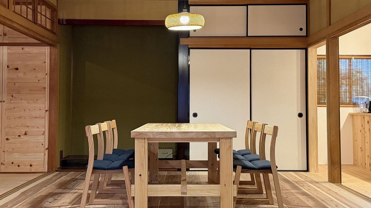 The dining table, its solid-wood top thick and heavy